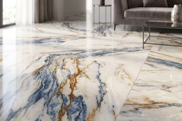 Polished large-format marble-look porcelain floor with blue, charcoal, and gold veining in a contemporary living room.