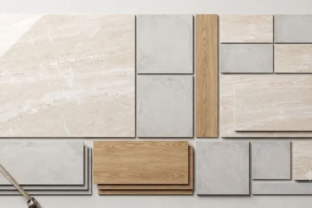 A variety of porcelain tile samples in different sizes and finishes, including marble-look, concrete-look, and wood-look planks, with a measuring tape.