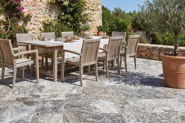 Silver travertine pool coping and paving around a terrace pool.
