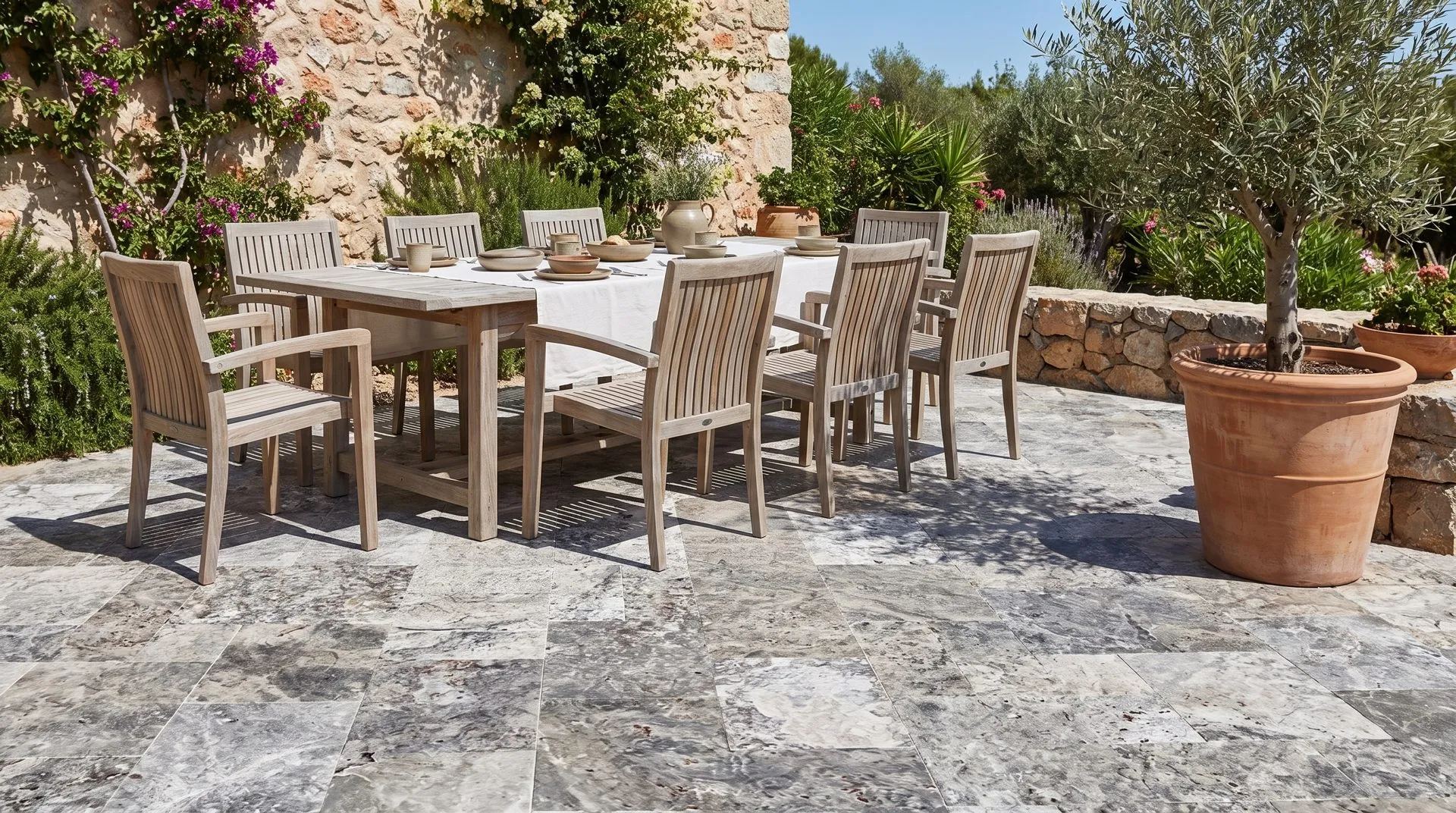 Silver travertine coping and paving around a pool terrace