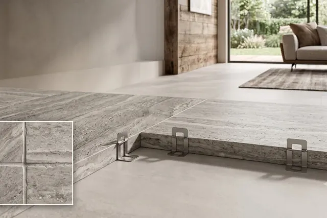 Large-format rectified stone-look tiles being installed with a leveling system for thin, precise grout joints.